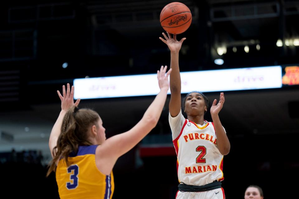 Purcell Marian guard Dee Alexander (2) scores over Bryan center Kailiee Thiel (3) during Thursday's OHSAA Division II state semifinal.