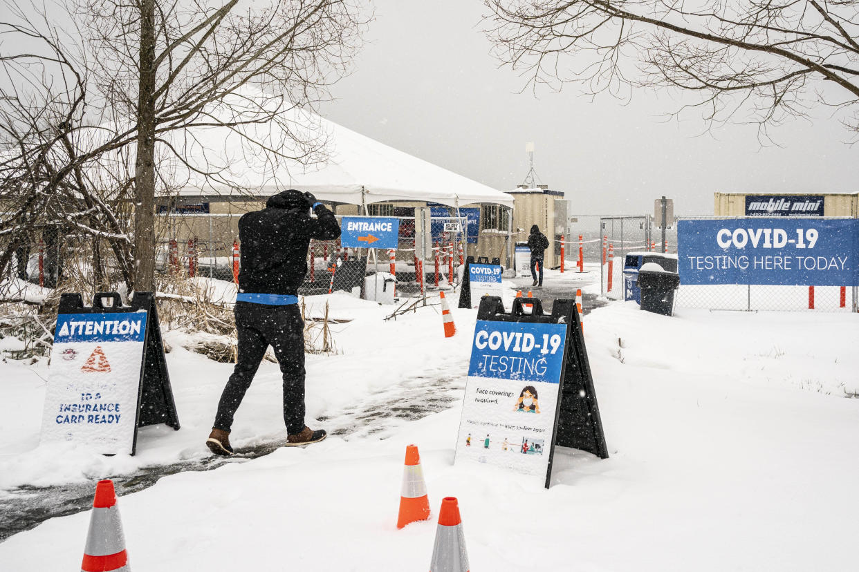People enter a COVID-19 testing site on February 13, 2021 in Seattle, Washington. A large winter storm dropped heavy snow across the region. (David Ryder/Getty Images)