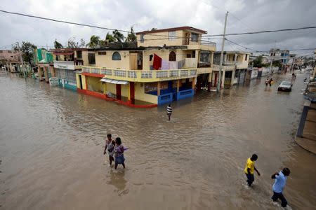 People walk in a flooded area after Hurricane Matthew in Les Cayes, Haiti, October 5, 2016. REUTERS/Andres Martinez Casares