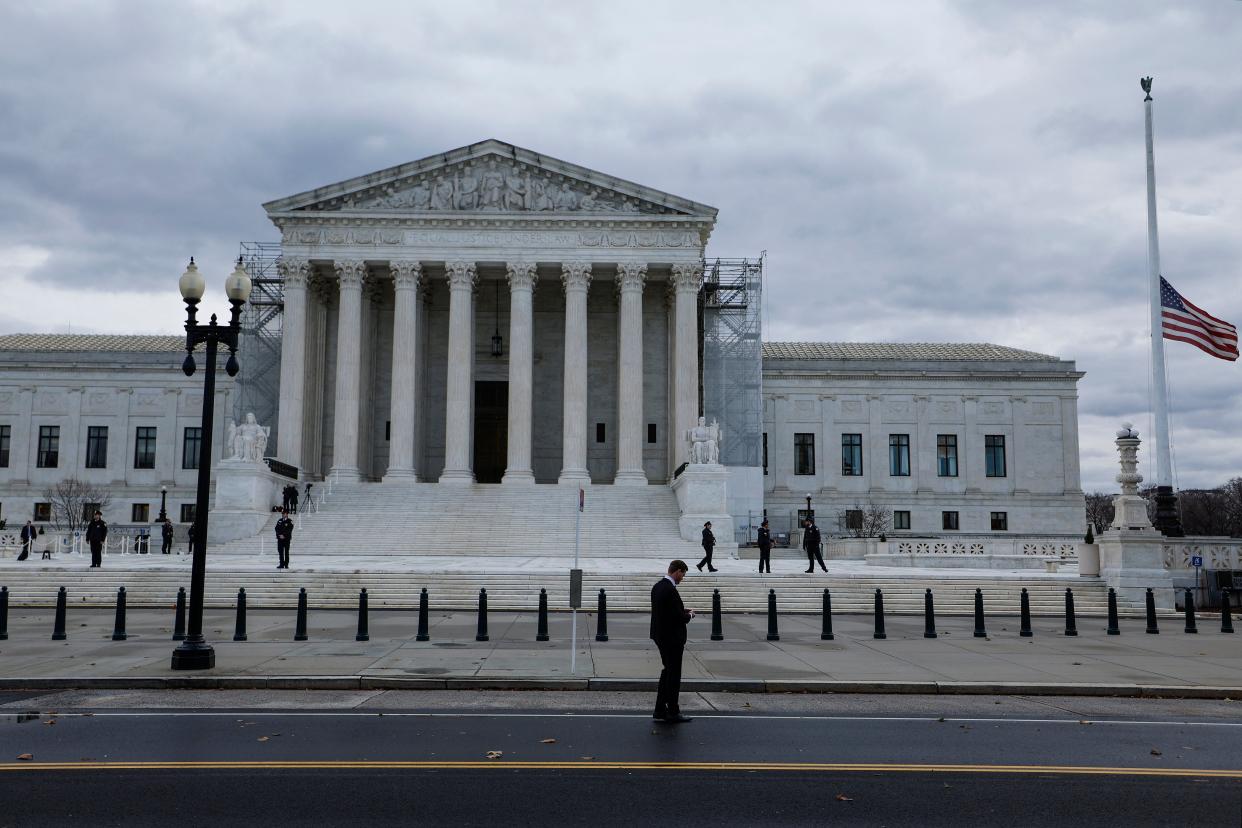 Flags fly at half-staff on the front plaza of the U.S. Supreme Court Building before the funeral service for retired Supreme Court Justice Sandra Day O'Connor on December 18, 2023 in Washington, DC.