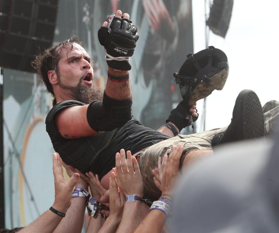 A fan surfs over the crowd at the 2022 edition of Welcome to Rockville in Daytona Beach. Crews are already at work assembling stages and other structures ahead of the four-day heavy-metal music festival that runs May 9-12 at Daytona International Speedway.