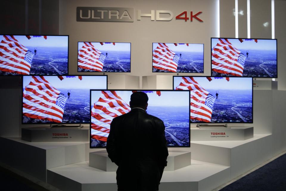 A show attendee looks at the Ultra HD 4K displays at the Toshiba booth at the International Consumer Electronics Show on Thursday, Jan. 9, 2014, in Las Vegas. (AP Photo/Jae C. Hong)