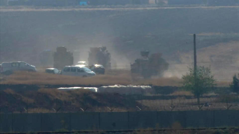 Military vehicles move in convoy along a road in Sevimli, Mardin Province, Turkey, Friday Nov. 1, 2019. Turkey and Russia launched joint patrols Friday in northeastern Syria, under a deal that halted a Turkish offensive against Syrian Kurdish fighters who were forced to withdraw from the border area following Ankara's incursion. (AP Photo)