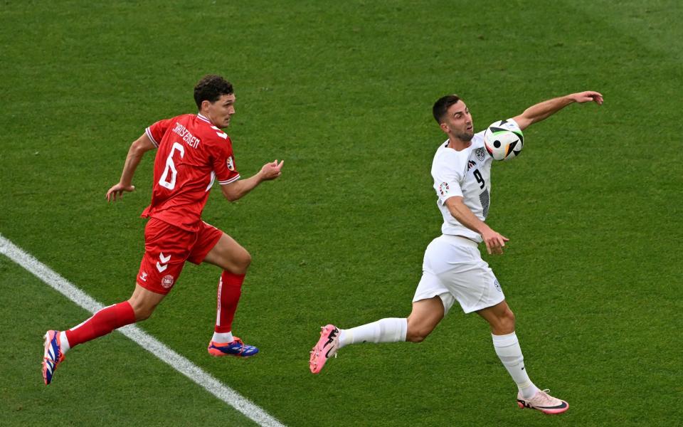 Andraz Sporar controls the ball on the chest before volleying wide.