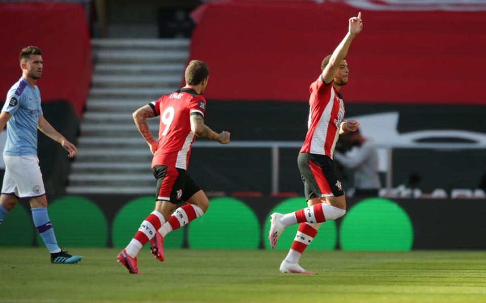 Che Adams of Southampton is congratulated by team-mate Danny Ings after he scores a goal to make it 1-0during the Premier League match between Southampton FC and Manchester City at St Mary's Stadium on July 05, 2020 in Southampton, England. Football stadiums around Europe remain empty due to the Coronavirus pandemic as government social distancing laws prohibit fans inside venues resulting in games being played behind closed doors. - GETTY IMAGES