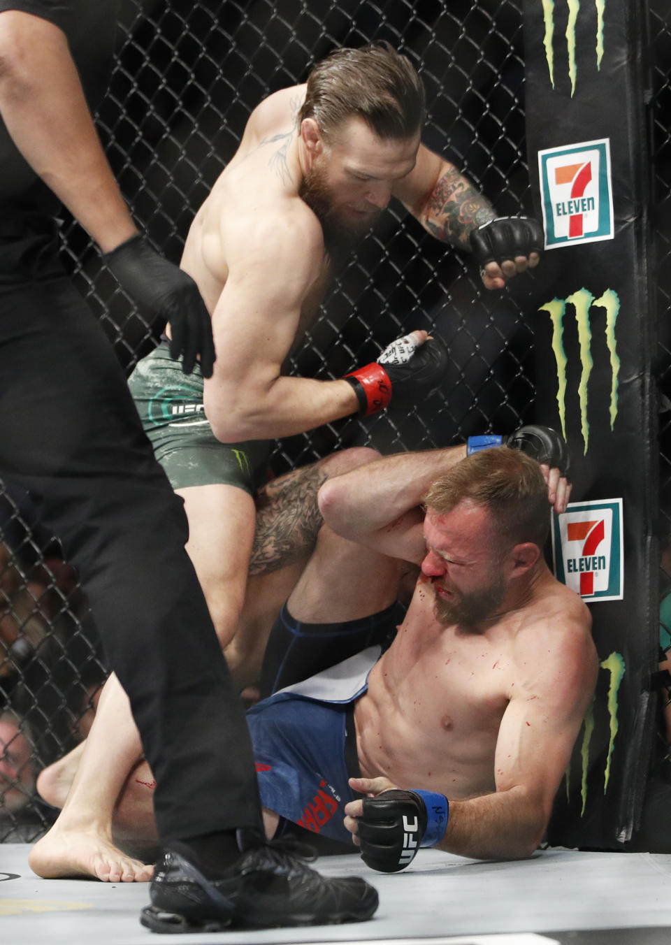 Conor McGregor, top, fights Donald "Cowboy" Cerrone during a UFC 246 welterweight mixed martial arts bout Saturday, Jan. 18, 2020, in Las Vegas. (AP Photo/John Locher)