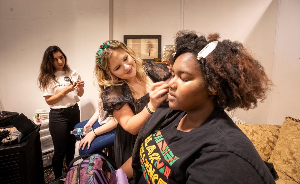 Makeup artist Ciara Liebl , left does Gianna Barnes facial makeup during an event at at Top Buttons Boutique in Winter Haven.  Top Buttons is hosted a day of service for at-risk girls by offering clothes and life skills. ERNST PETERS/ THE LEDGER