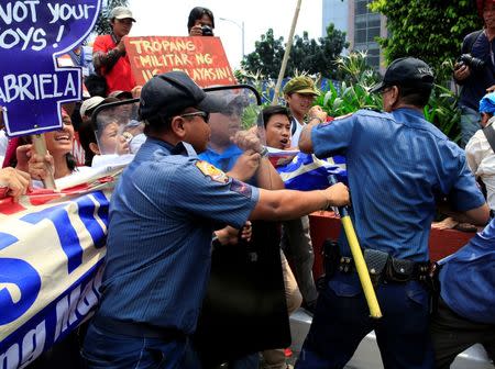 Anti-riot policemen block protesters denouncing the visit of U.S. Secretary of State John Kerry and the Supreme Court's decision to uphold, with finality, the constitutionality of the Enhanced Defense Cooperation Agreement (EDCA) during a protest outside the U.S. embassy in metro Manila, Philippines July 27, 2016. REUTERS/Romeo Ranoco
