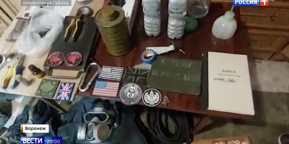 A still from a Russian state media Russia-1 report, showing what it claims is a mass of military paraphernalia found at the site of a FSB operation