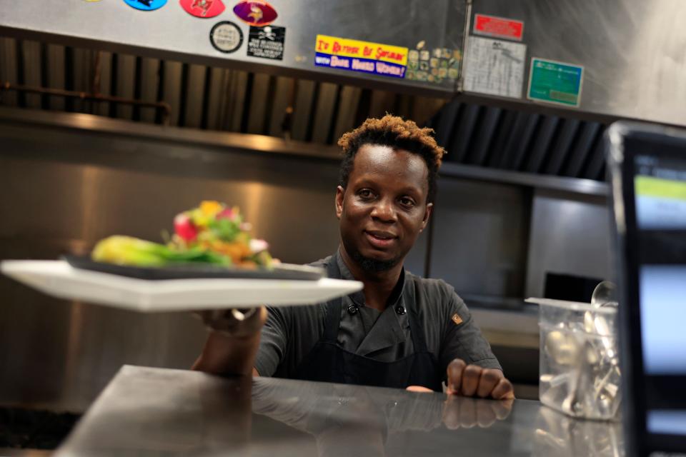 Executive chef and owner Richard Robinson serves an order at Pink Salt Restaurant + Veveta Tapas, also known as Vevetas Tapas by Pink Salt,  in the Lakewood neighborhood of Jacksonville.