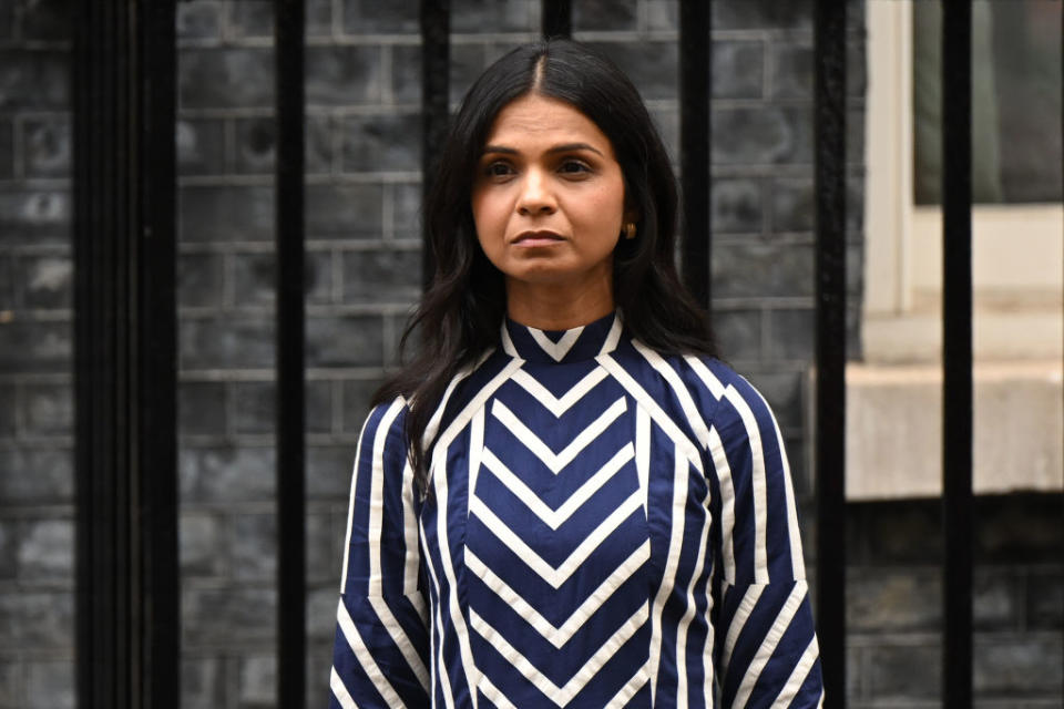 Prime Minister Rishi Sunak wife Akshata Murty outside 10 Downing Street looks on as they leave 10 Downing Street. She wore a ka-sha dress in the colors of the united kingdom flag in blue red and white.