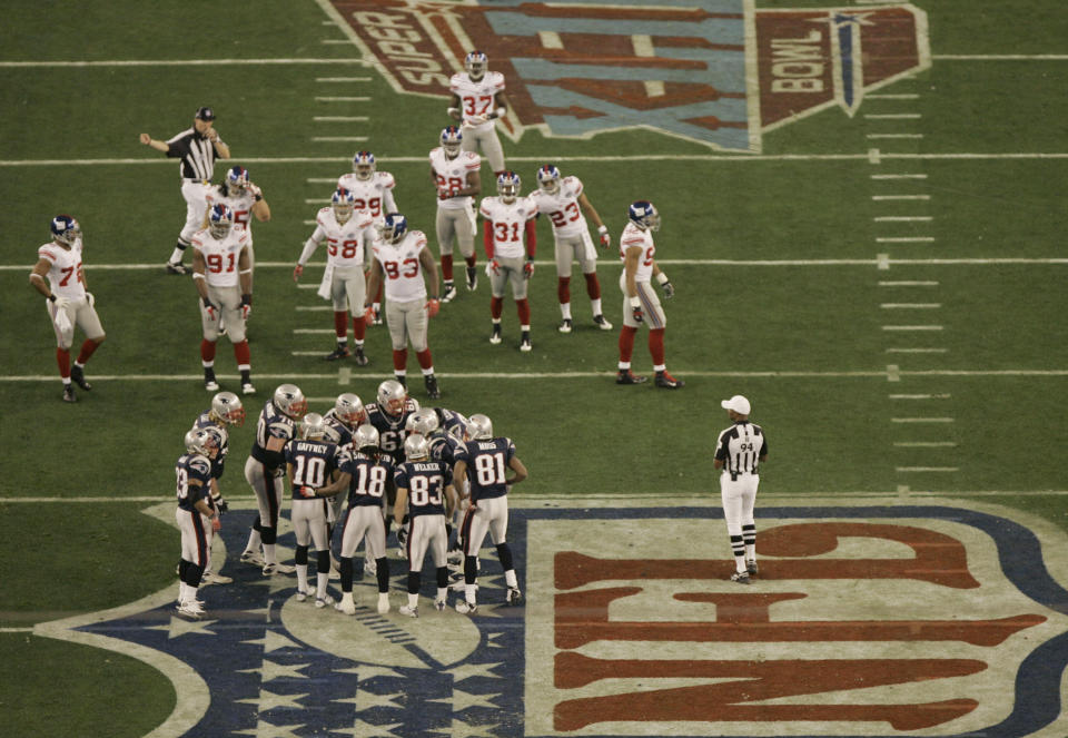 FILE - In this Feb. 3, 2008, file photo, New England Patriots players and the New York Giants players take the field during the second quarter of the Super Bowl XLII football game at University of Phoenix Stadium in Glendale, Ariz. The NFL’s players have made it no secret they prefer playing on natural grass as opposed to synthetic turf. They’ll get their wish in Super Bowl 57. (AP Photo/Charlie Riedel, File)