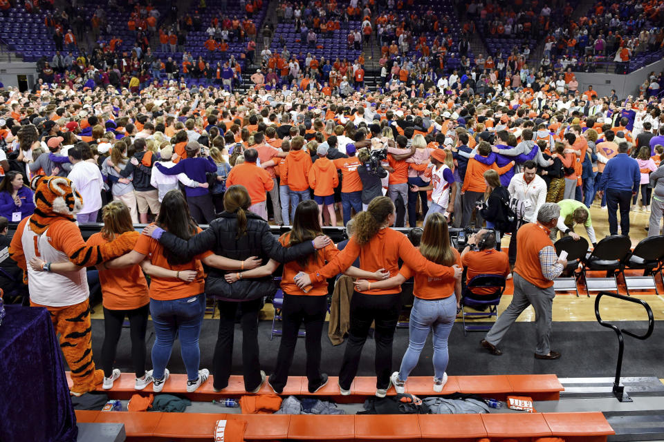 Clemson fans and players celebrate after an NCAA college basketball game against Florida State Saturday, Feb. 29, 2020, in Clemson, S.C. Clemson won 70-69. (AP Photo/Richard Shiro)