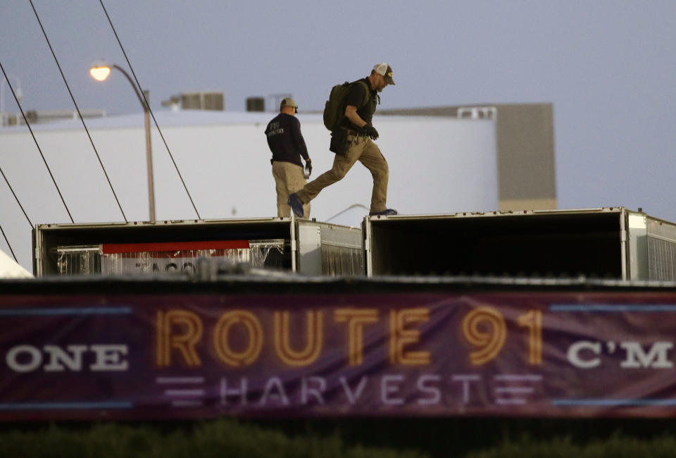 <p>FBI agents walk on the roof of boxes inside the concert grounds where a mass shooting occurred in Las Vegas, Tuesday, Oct. 3, 2017. (Photo: John Locher/AP) </p>