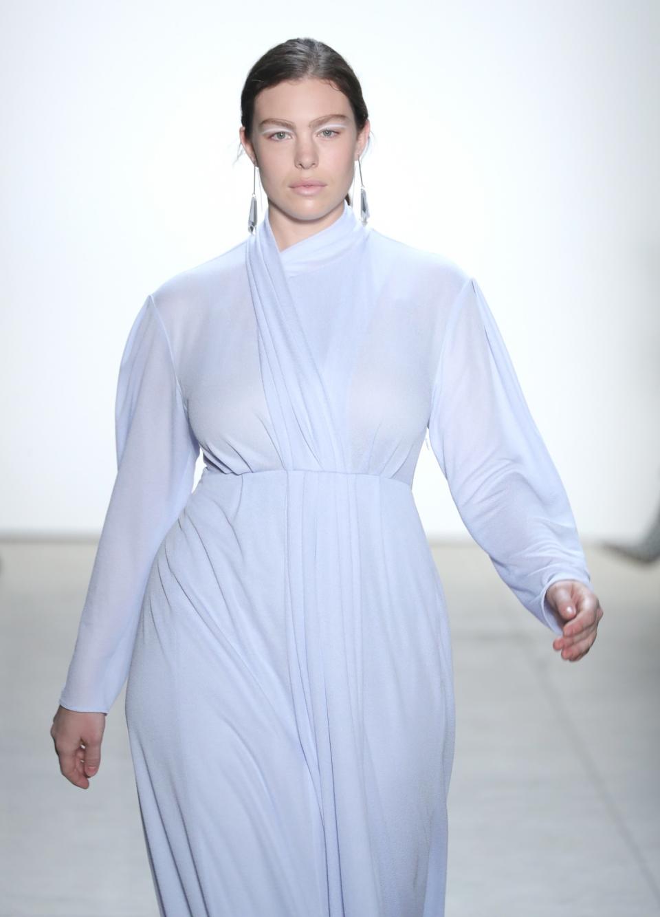 A stunning cascade of baby blue drapes over this stunning plus-size model at Tome.