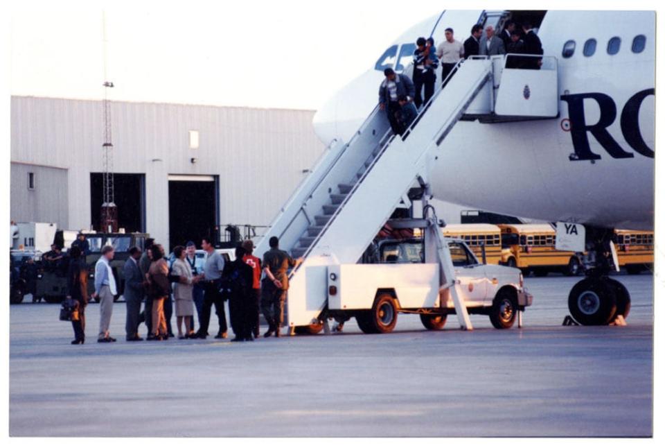Kosovar refugees disembark from their Royal Airlines charter flight, CFB Trenton, 1999