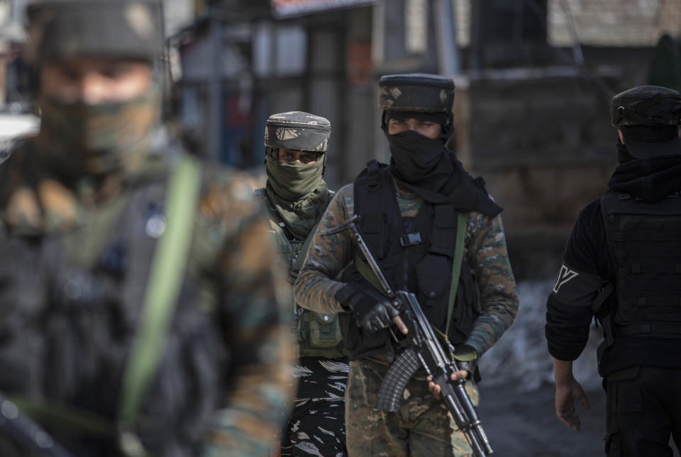 Indian paramilitary soldiers arrive near the site of a shootout in Srinagar, Indian controlled Kashmir, Friday, Feb. 19, 2021. Anti-India rebels in Indian-controlled Kashmir killed two police officers in an attack Friday in the disputed region’s main city, officials said. Elsewhere in the Himalayan region, three suspected rebels and a policeman were killed in two gunbattles. (AP Photo/Mukhtar Khan)