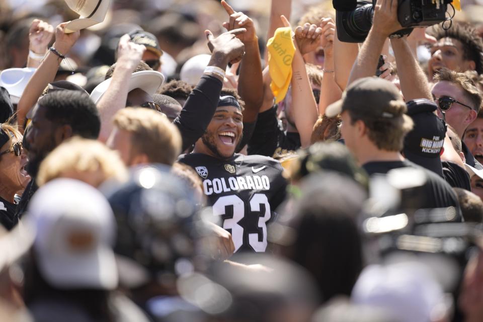 Colorado linebacker Devee Harris (33) celebrates with fans as they storm the field after game against Nebraska Saturday, Sept. 9, 2023, in Boulder, Colo. | David Zalubowski, Associated Press