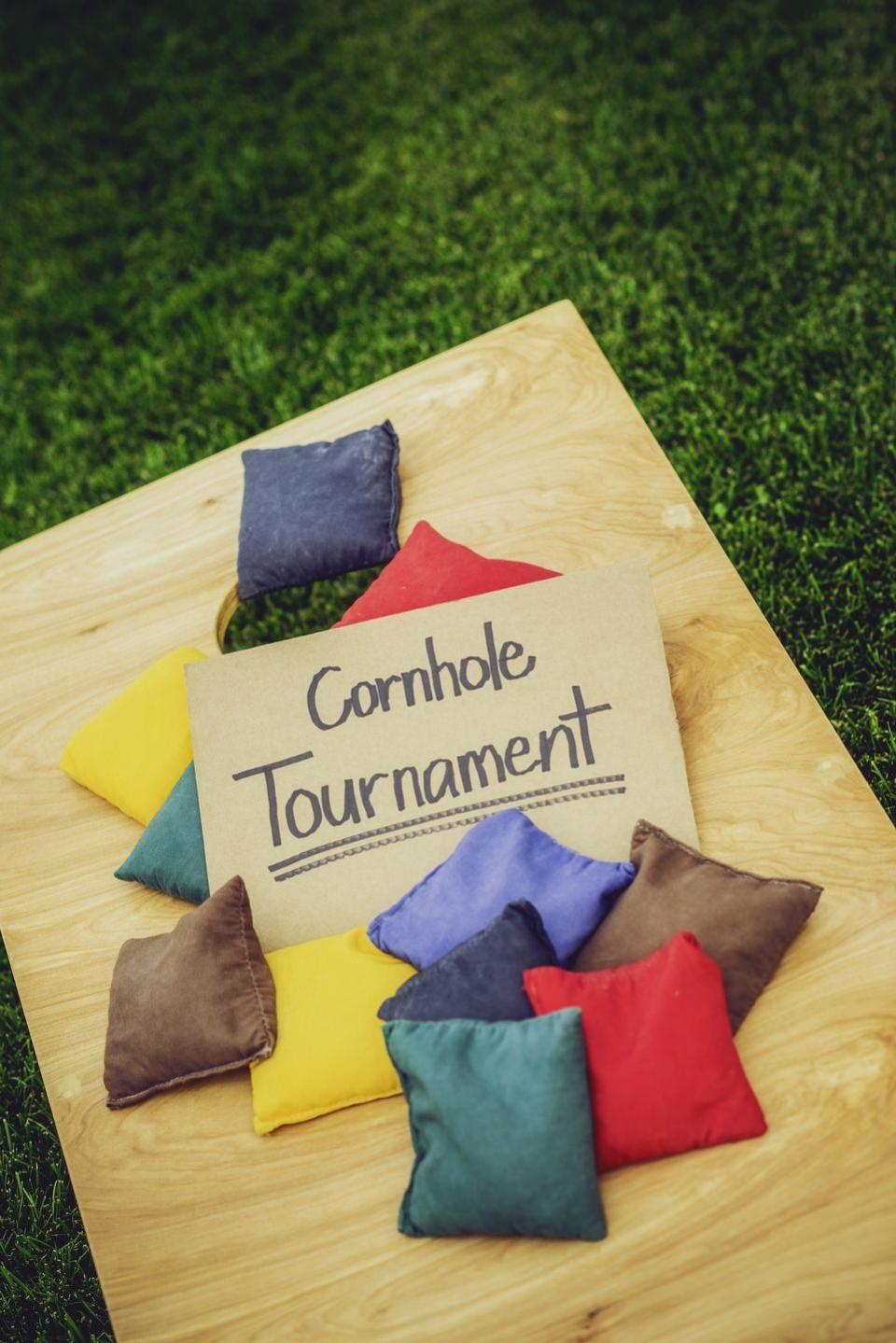 summer activities cornhole board and bags with tournament sign