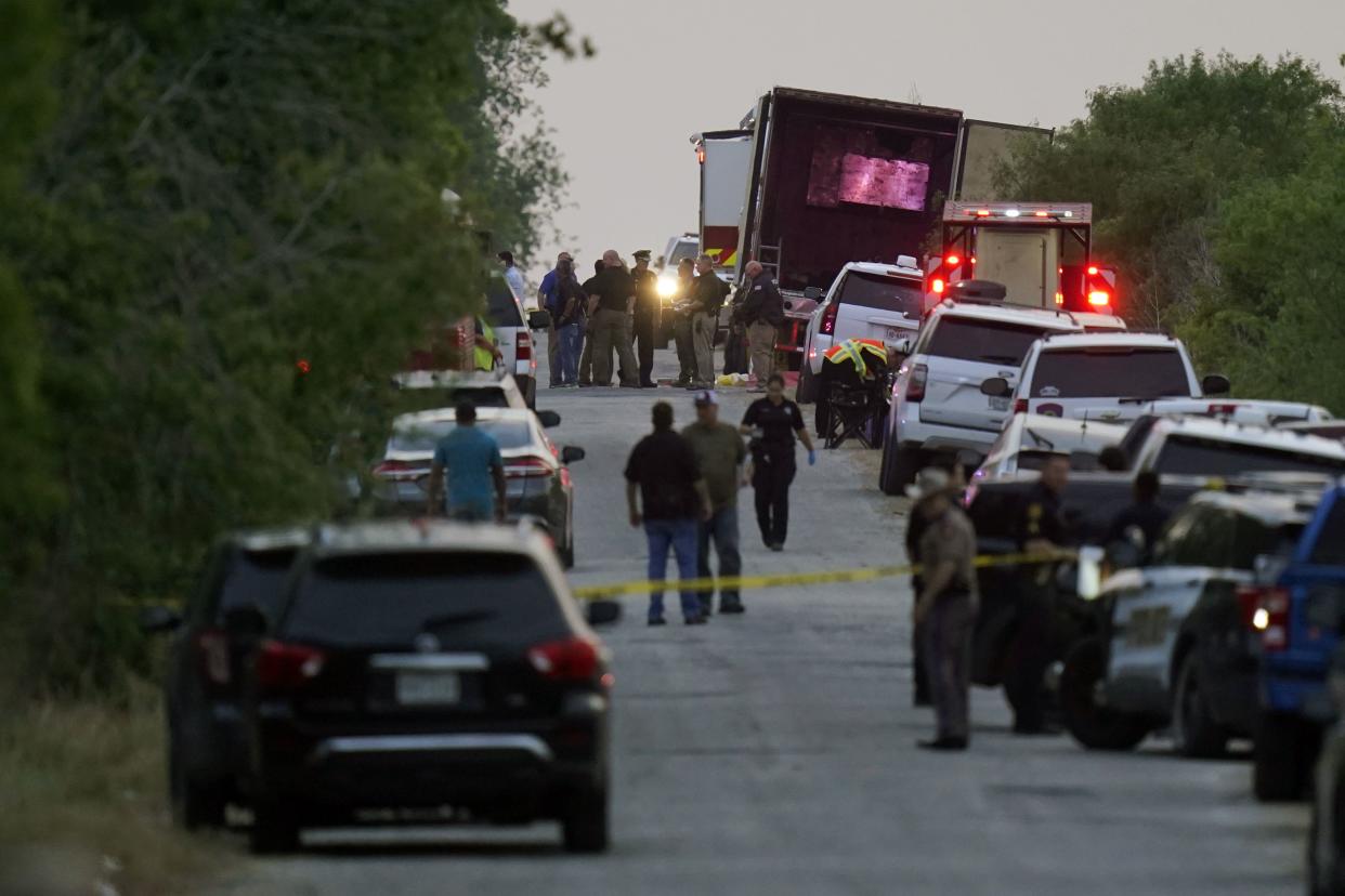 Police and other first responders work the scene where officials say dozens of people have been found dead and multiple others were taken to hospitals with heat-related illnesses after a semitrailer containing suspected migrants was found Monday.