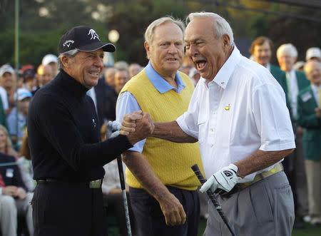 Honorary starter Arnold Palmer (R) is congratulated by fellow golf greats Gary Player (L) and Jack Nicklaus (C) after hitting his drive during the ceremonial tee-off before first round play in the 2012 Masters Golf Tournament at the Augusta National Golf Club in Augusta, Georgia. REUTERS/Brian Snyder