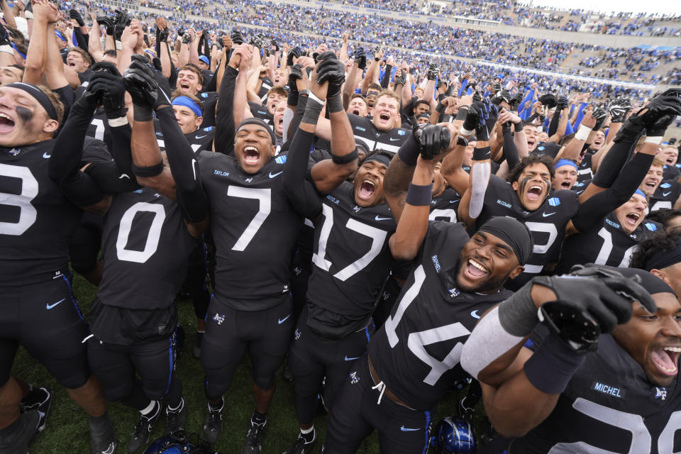 Air Force players sing the school song with cadets after an NCAA college football game against Navy, Saturday, Oct. 1, 2022, at Air Force Academy, Colo. (AP Photo/David Zalubowski)