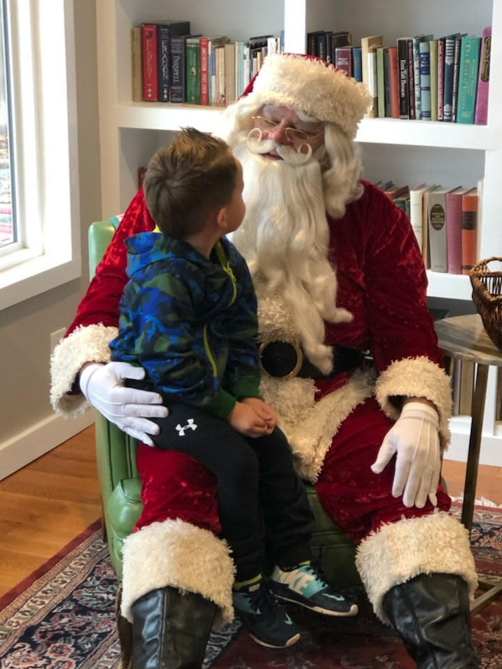 Santa Anthony White listening intently to a little boy. (Photo courtesy of Anthony White)