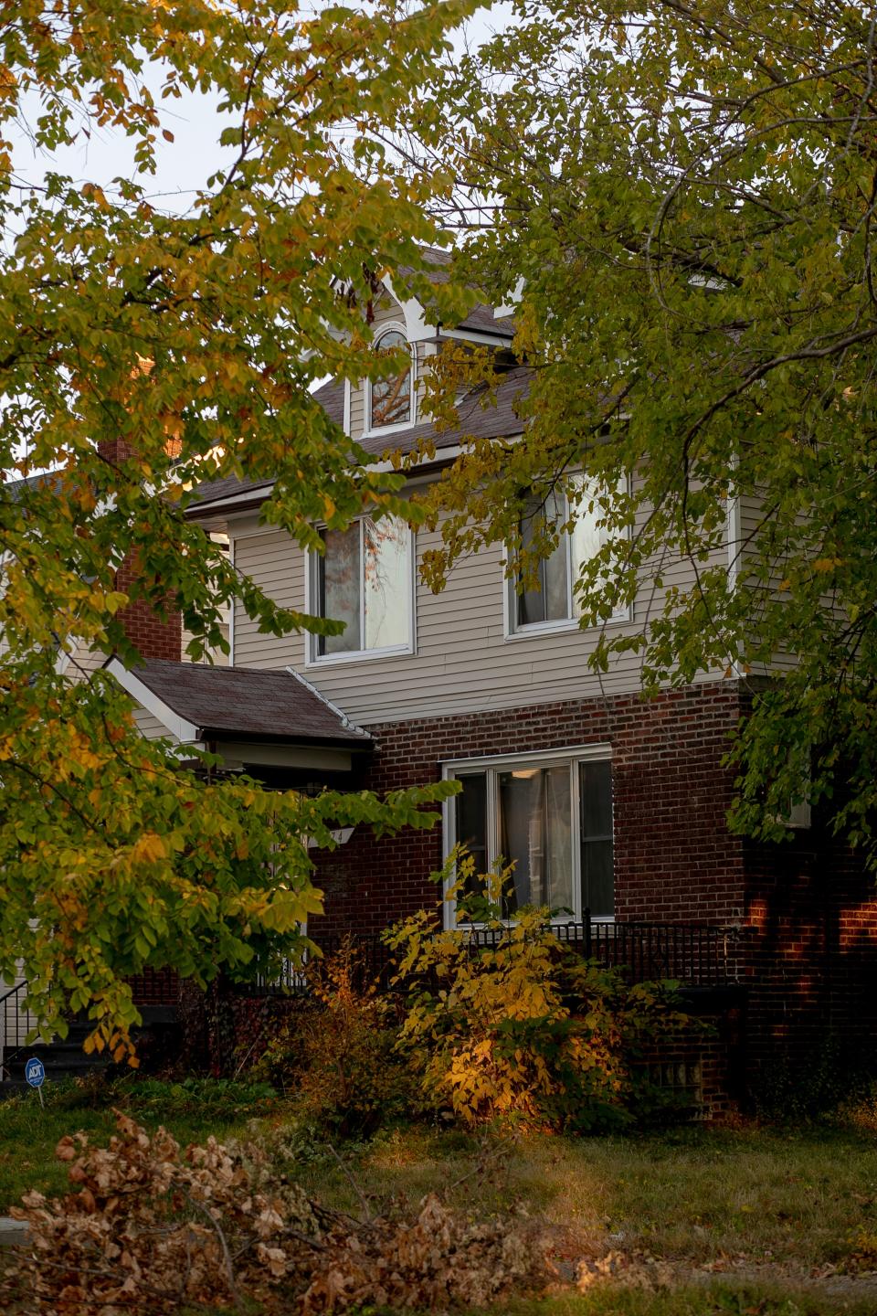 A photo of a house behind trees