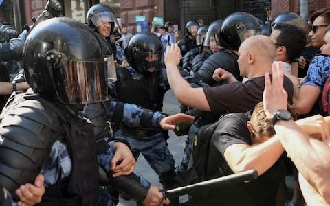 Protesters face off with riot police at a demonstration to demand independent candidates be registered - Credit: Kirill Kudryavtsev/AFP/Getty