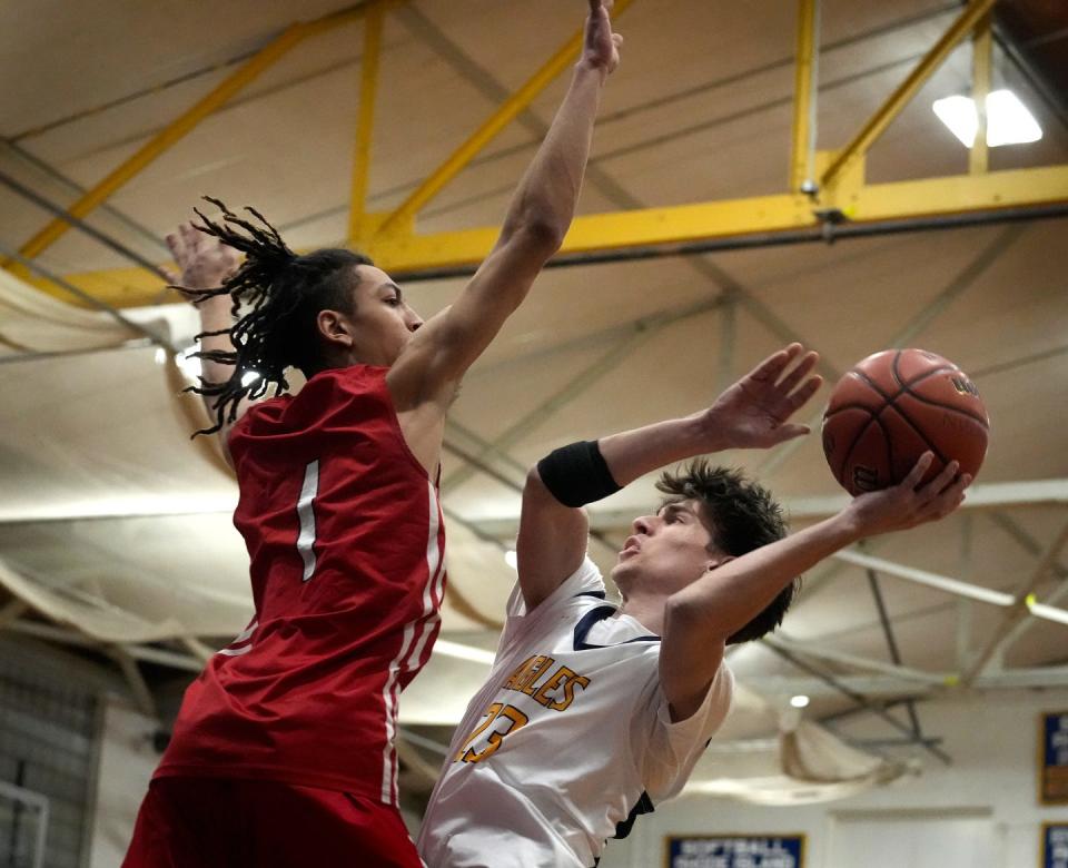 Barrington Eagle Matthew Raffa tries to get a shot off against Townie guard Jayveeon Gonsalves in the first half.  