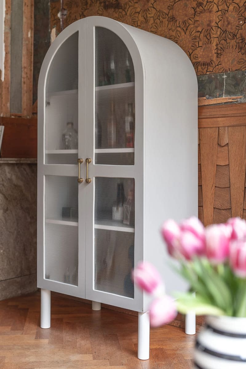 Arched cabinet with reeded glass panels on the two front doors