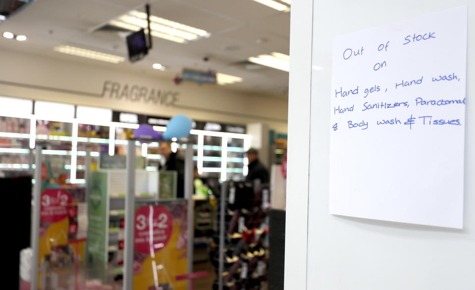 A chemist shop displays a sign in London, Tuesday, March 17, 2020. For most people, the new coronavirus causes only mild or moderate symptoms, such as fever and cough. For some, especially older adults and people with existing health problems, it can cause more severe illness, including pneumonia. (AP Photo/Kirsty Wigglesworth)