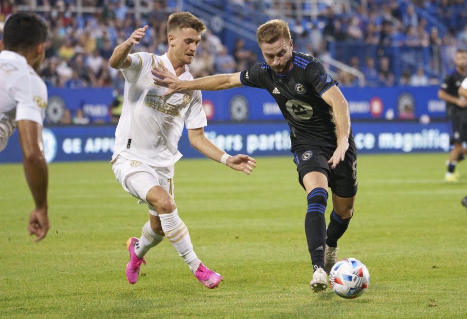 CF Montreal midfielder Djordje Mihailovic fends off Atlanta United's Amar Sejdic during the first half of an MLS soccer match Wednesday, Aug. 4, 2021, in Montreal. (Paul Chiasson/The Canadian Press via AP)P)