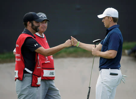 Golf - Australian Open Golf Tournament - Sydney, Australia - 20-11-2016 Jordan Spieth of the United States (R) fist bumps with his caddie Michael Greller after making it to a playoff on the 18th hole prior to winning the tournament. REUTERS/Jason Reed