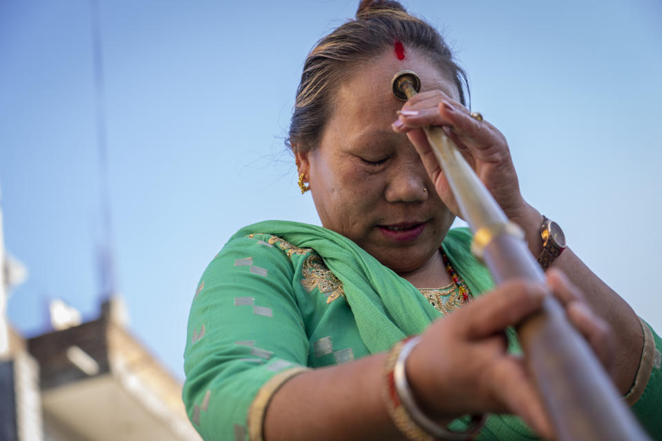 Maya Ghale, 48, worships her instrument before a rehearsal of the Shrijanshil Mahila Sanstha, or the Self-Reliant Women’s Group, in Kathmandu, Nepal, Tuesday, March 5, 2024. Once associated only with men from the Damai community, part of the lowest caste, nine women from varied castes have come together in this band to play the naumati baja, or nine traditional instruments. (AP Photo/Niranjan Shrestha)