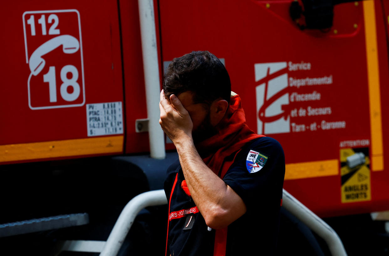 A firefighter reacts as he works to contain a fire in Saint-Magne, as wildfires continue to spread in the Gironde region of southwestern France, August 11, 2022. REUTERS/Stephane Mahe