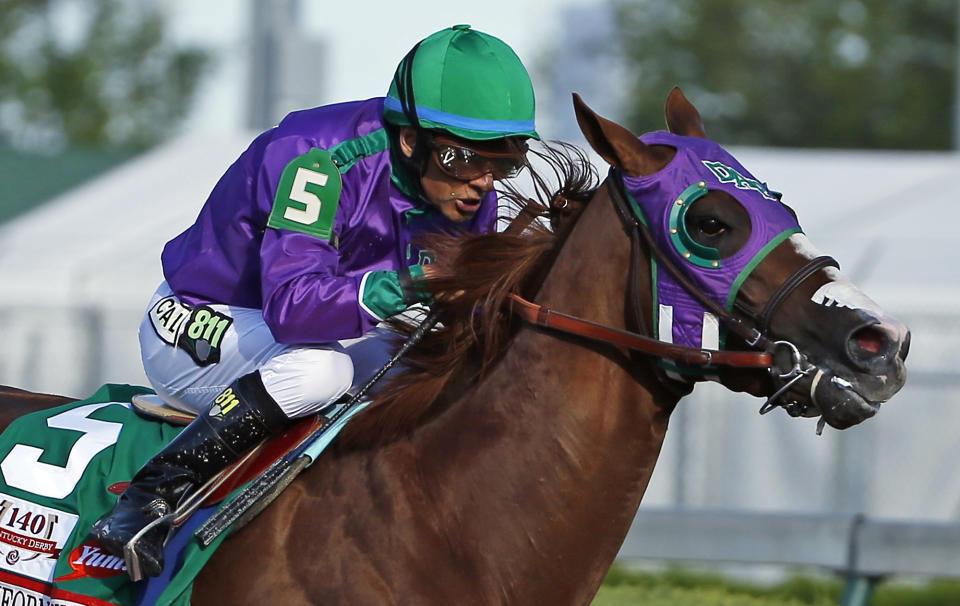 FILE - In this May 3, 2014, file photo, jockey Victor Espinoza rides California Chrome to win the 140th running of the Kentucky Derby horse race at Churchill Downs in Louisville, Ky. The California colt will be running in the Preakness with a bulls-eye on his back as perhaps racing's next superstar. He figures to face eight or nine rivals in the middle leg of the Triple Crown series, and one of them might be a filly. (AP Photo/Matt Slocum, File)