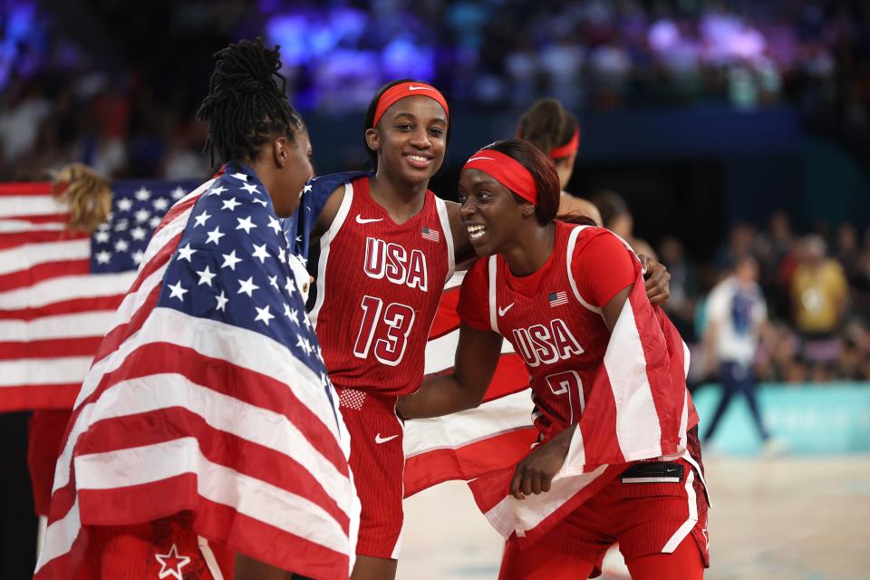 PARIS, FRANCE - AUGUST 11: Jackie Young #13, Kahleah Copper #7, and Chelsea Gray #8 of Team United States celebrate after their team's victory against Team France during the Women's Gold Medal game between Team France and Team United States on day sixteen of the Olympic Games Paris 2024 at Bercy Arena on August 11, 2024 in Paris, France. (Photo by Matthew Stockman/Getty Images) ORG XMIT: 776138675 ORIG FILE ID: 2166338627