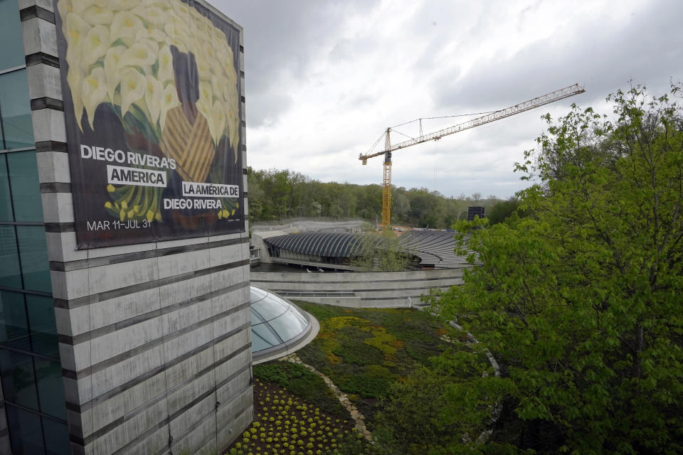 The Crystal Bridges Museum of American Art is pictured Wednesday, April 19, 2023, in Bentonville, Ark. The crane at rear is working on the site of a new medical school. (AP Photo/Sue Ogrocki)