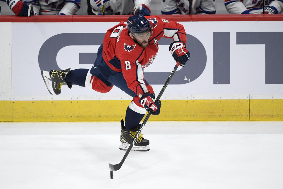 Washington Capitals left wing Alex Ovechkin (8) passes the puck during the second period of an NHL hockey game against the New York Rangers, Sunday, March 28, 2021, in Washington. (AP Photo/Nick Wass)