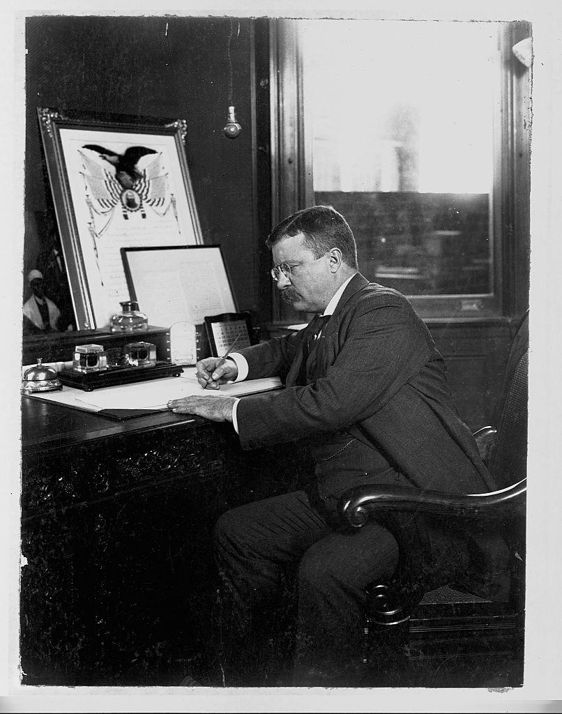 President Theodore Roosevelt signs a Thanksgiving proclamation in his office in 1902<span class="copyright">Corbis/VCG via Getty Images</span>