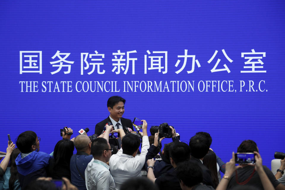 Yang Guang, spokesman of the Hong Kong and Macau Affairs Office of the State Council, is approached by reporters as he prepares to leave after a press conference about the ongoing protests in Hong Kong, at the State Council Information Office in Beijing, Monday, July 29, 2019. Yang said some Western politicians are stirring unrest in Hong Kong in hopes of creating difficulties that will impede China’s overall development. (AP Photo/Andy Wong)