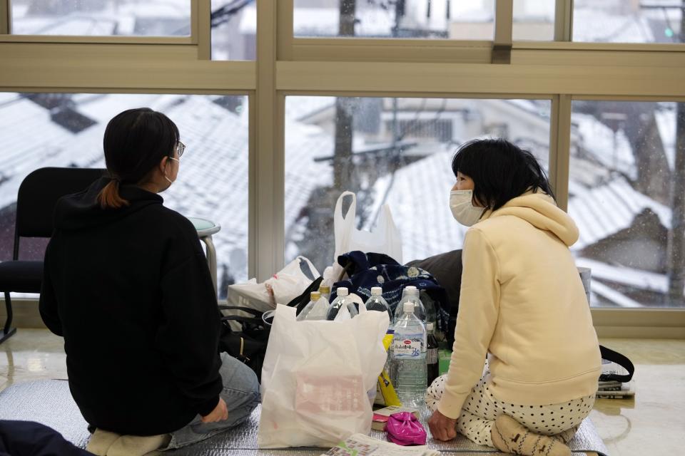 Evacuees take refuge at an evacuation center in Wajima in the Noto peninsula facing the Sea of Japan, northwest of Tokyo, Sunday, Jan. 7, 2024. Monday's temblor decimated houses, twisted and scarred roads and scattered boats like toys in the waters, and prompted tsunami warnings. (AP Photo/Hiro Komae)
