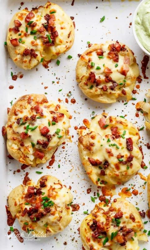 <p>Cafe Delites</p><p>Crispy and loaded cheesy bacon smashed potatoes with chives and an avocado crema!</p><p><strong>Get the recipe: <a href="https://cafedelites.com/cheesy-bacon-smashed-potatoes/" rel="nofollow noopener" target="_blank" data-ylk="slk:Cheesy Bacon Smashed Potatoes;elm:context_link;itc:0;sec:content-canvas" class="link rapid-noclick-resp">Cheesy Bacon Smashed Potatoes</a></strong></p>