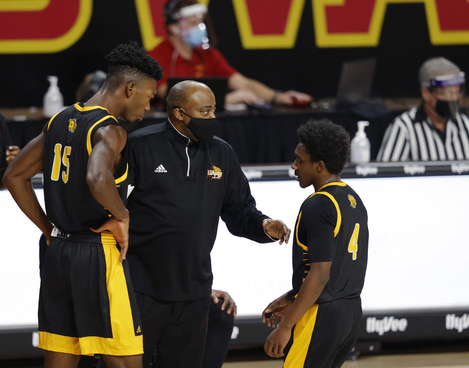 Arkansas-Pine Bluff head coach George Ivory, center, talks with forward Alvin Stredic, left, and guard Joshuwa Johnson, right, during a timeout in the first half half of an NCAA college basketball game against Iowa State, Sunday, Nov. 29, 2020, in Ames, Iowa. (AP Photo/Matthew Putney)