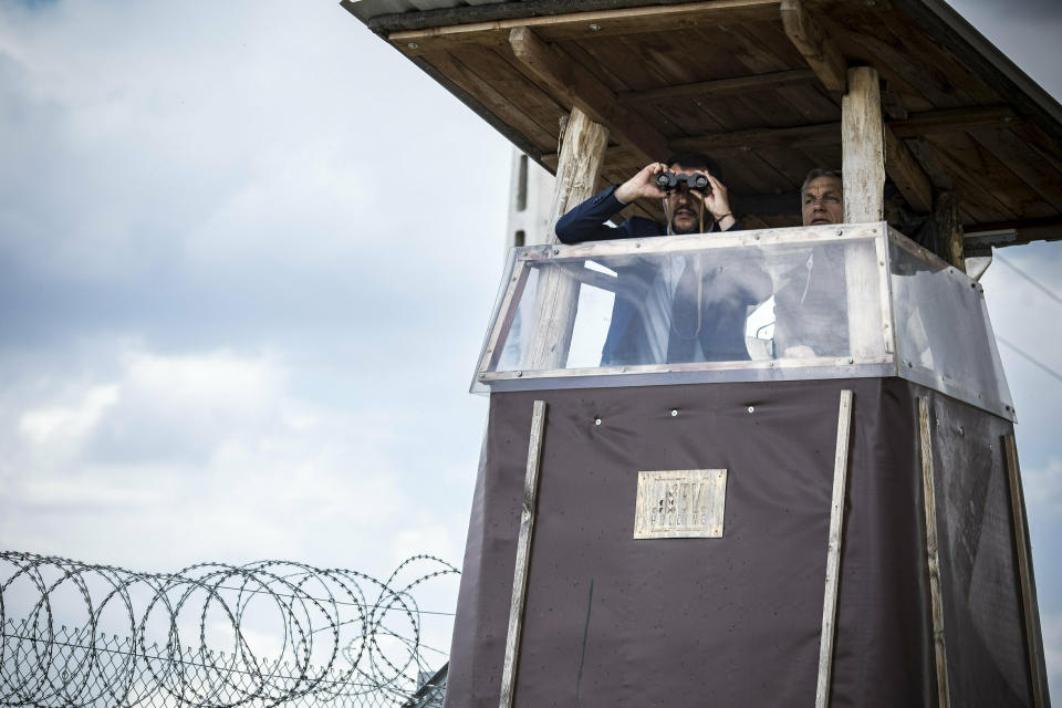 In this handout photo provided by the Hungarian Prime Minister's Press Office shows Hungarian Prime Minister Viktor Orban, right, and Italian Interior Minister Matteo Salvini observe the border from a watchtower during their visit at the Hungarian-Serbian border near Roszke, 180 kms southeast of Budapest, Hungary, Thursday, May 2, 2019. (Balazs Szecsodi/Hungarian Prime Minister's Press Office/MTI via AP)