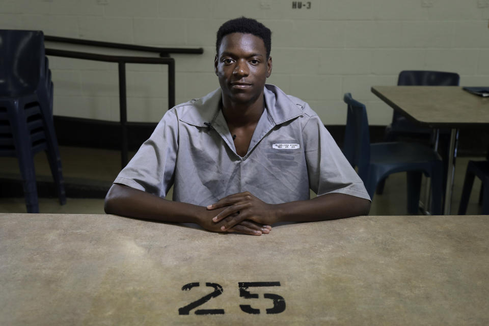 In this July 18, 2019, photo, Josh Williams poses for a portrait at the Missouri Eastern Correctional Center in Pacific, Mo. Williams took to the streets of Ferguson the night after the shooting of Michael Brown. He said he found his calling in activism. In what he called a fit of anger a few months after Brown’s death, Williams grabbed a few things from a gas station and set fire to a trash can during a confrontation with police. He was convicted and sentenced to eight years in prison. (AP Photo/Jeff Roberson)