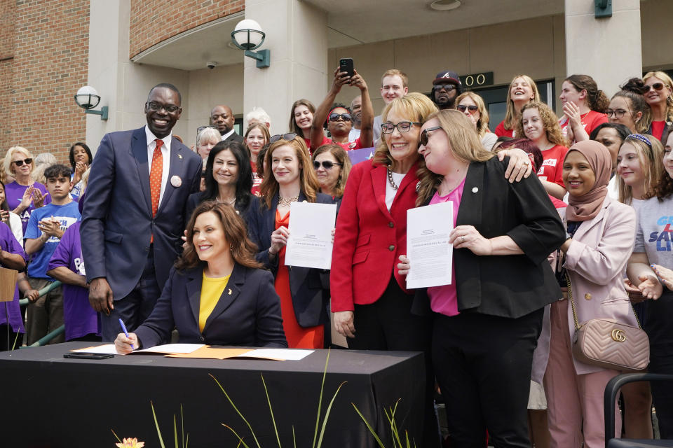 Michigan Gov. Gretchen Whitmer signs legislation, Monday, May 22, 2023, in Royal Oak, Mich. The package of legislation being signed will create extreme risk protection orders, which authorize family, police officers, or medical professionals to seek a court order to temporarily keep guns out of the hands of someone who represents a danger to themselves or others. (AP Photo/Carlos Osorio)