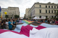 Participants wave a huge flag during the annual Pride parade, in Athens, Saturday, June 10, 2023. June marks the beginning of Pride month in the U.S. and many parts of the world, a season intended to celebrate the lives and experiences of LGBTQ+ communities and to protest against attacks on hard-won civil rights gains. (AP Photo/Yorgos Karahalis)