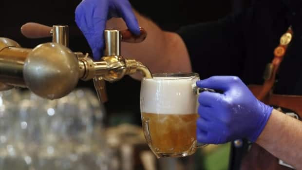 Starting Monday, bars will be able to serve alcohol until midnight and close at 2 a.m. Restaurants can also serve alcohol until midnight under this decree.  (Peter David Josek/Associated Press - image credit)